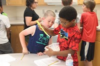 boys making pancakes as part of c v summer steam program.