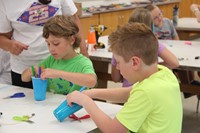 boys working on robots in c v summer steam program