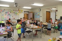 students working on three little pigs houses challenge houses wide shot of classroom