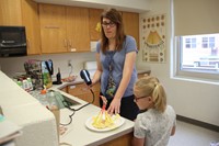 teacher testing three little pigs house challenge with blow dryer