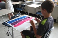 boy working on painting using nature