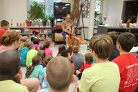 chris mckinney shows students how wool is spun farther shot