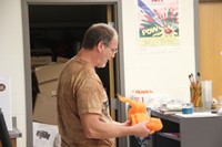 chris mckinney shows students orange wool