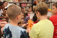 summer steam students are able to hold orange wool in hands