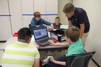 group watches tutorial video on robotics