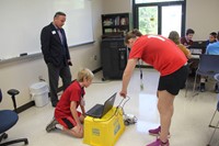 mister gill watching students test their robots