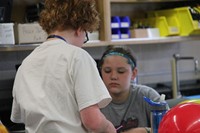 students work on project involving balloons