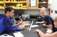 students build bridges made of popsicle sticks at boces summer steam academy