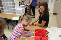 student coloring picture of apple at port dickinson elementary kindergarten orientation