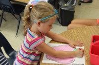 student coloring at port dickinson elementarys kindergarten orientation