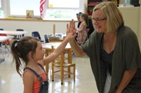 incoming kindergarten student and her new teacher high five at port dickinson elementary kindergarte