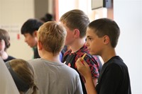 group of male students talking at middle school orientation