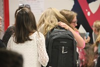 students hug when they see each other at middle school orientation