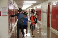 student finds his new locker at middle school orientation