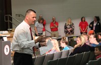 closer shot of principal attleson speaking with sixth grade students parents and guardians in audito