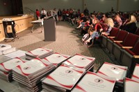 middle school agendas and students parents and guardians in seats at auditorium