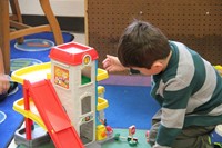 boy plays with toy garage