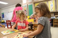 pre k students play with puzzles