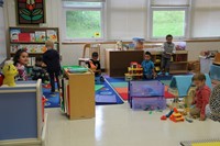 wide shot of pre k students playing in their classroom on first day