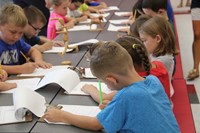 students sketch wooden figure