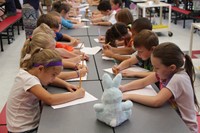 wide shot of students taking part in sketching lesson