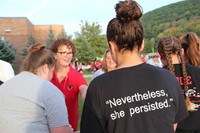 beth donahue hands student a hot dog