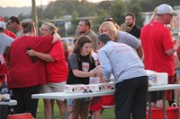 superintendent gill helps to serve food to student at rally in the valley event