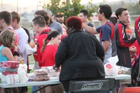 wide shot of c v staff member helping to serve donuts at rally in the valley event