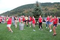 wide shot of students and teacher dancing at rally in the valley event