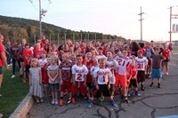 wide shot of students wearing jerseys listening to instructions for large group photo