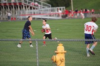 boys playing football next to c v stadium