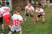 young students play with football game at rally in the valley event