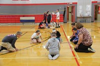 far shot of students working together in positive message team writing challenge