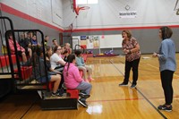 guidance counselors talk to middle school students in middle school gymnasium
