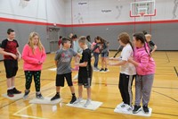 middle school students work together to get across imaginary lava game