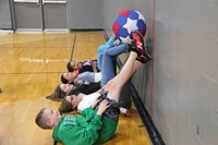 middle school students work together to move ball as part of team building exercise