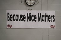 sign that reads because nice matters in middle school gym