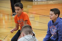 up close of students working together to write a positive message in team building exercise