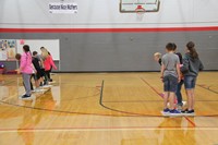 wide shot of students playing team building lava challenge game