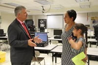 mister krause talks to parent and student at middle school open house
