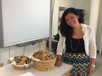 teacher stands next to cookies that students made for middle school open house