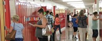 wide shot of middle school hallway filled with people during open house