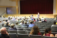 principal attleson talks to parents and guardians at middle school open house in auditorium