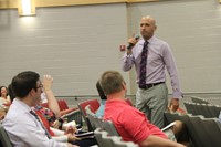 eynote speaker brian mendler speaking with staff