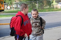 boys smile standing outside of chenango bridge elementary school on first day