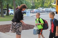 principal mary beth hammond speaks with two students about to enter first day of school at chenango 