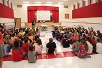 principal mary beth hammond talks to students about the school year in auditorium