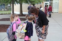 principal mary beth hammond talks with two students outside chenango bridge elementary school on fir