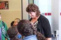 principal mary beth hammond welcomes chenango bridge elementary students at school entrance