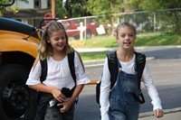 girls walk toward chenango bridge elementary school on first day